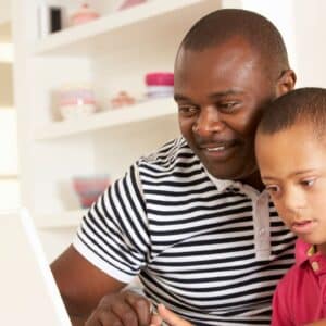 Father and son using tablet together.