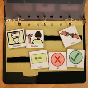 picture communication AAC notebook with symbols and words.