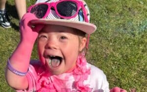 Little girl covered in pink having great fun at the park.