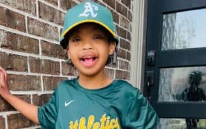 Child ready to take turns playing baseball.