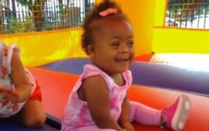 Little girl having fun in bouncy.