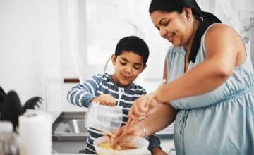 Mother and son engaging in a language-rich cooking activity.