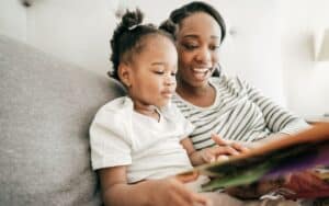 Mother sharing a book with her daughter.