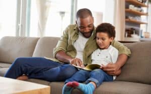 Father sharing a book with his son.